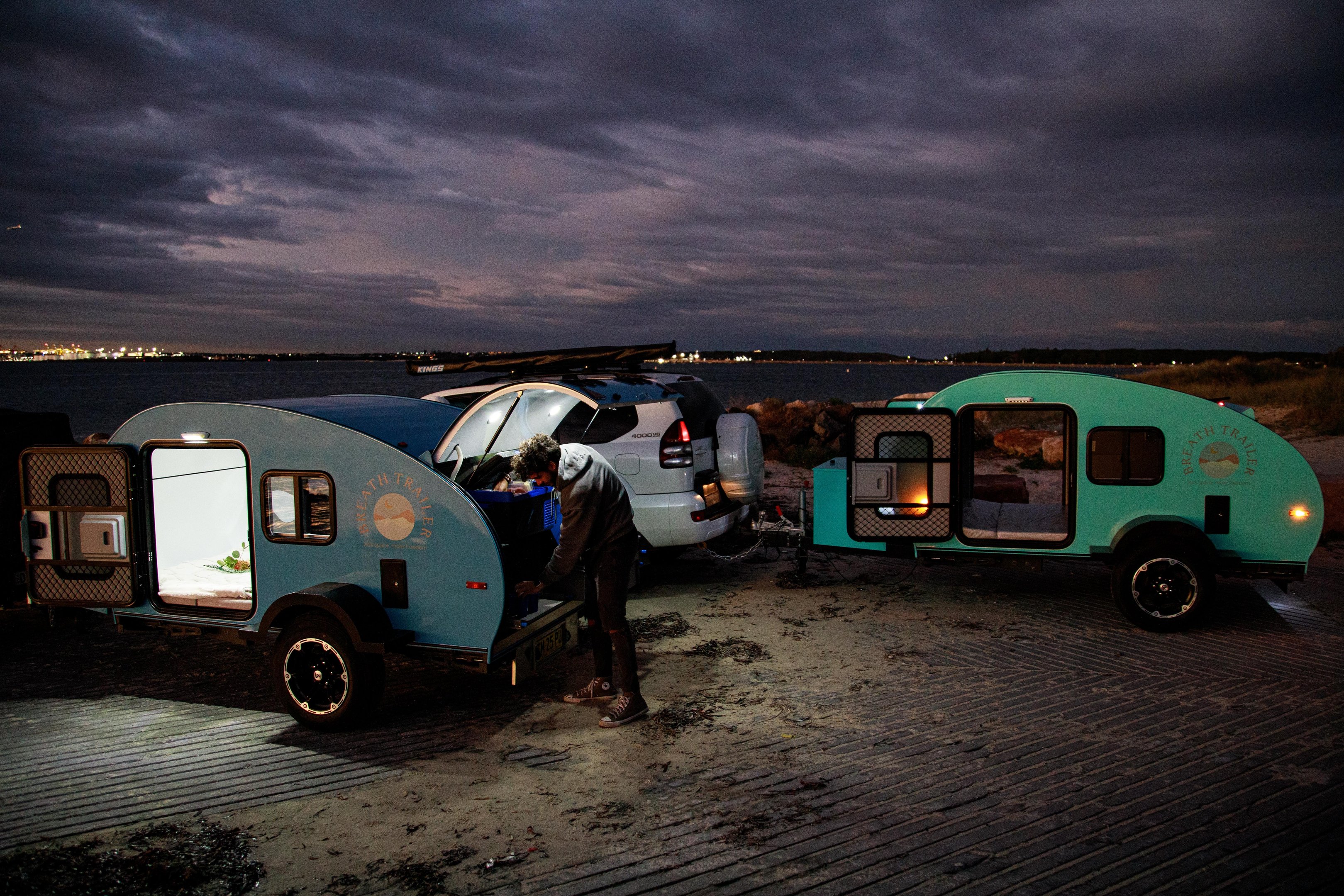 Breath Trailers on beach at dusk